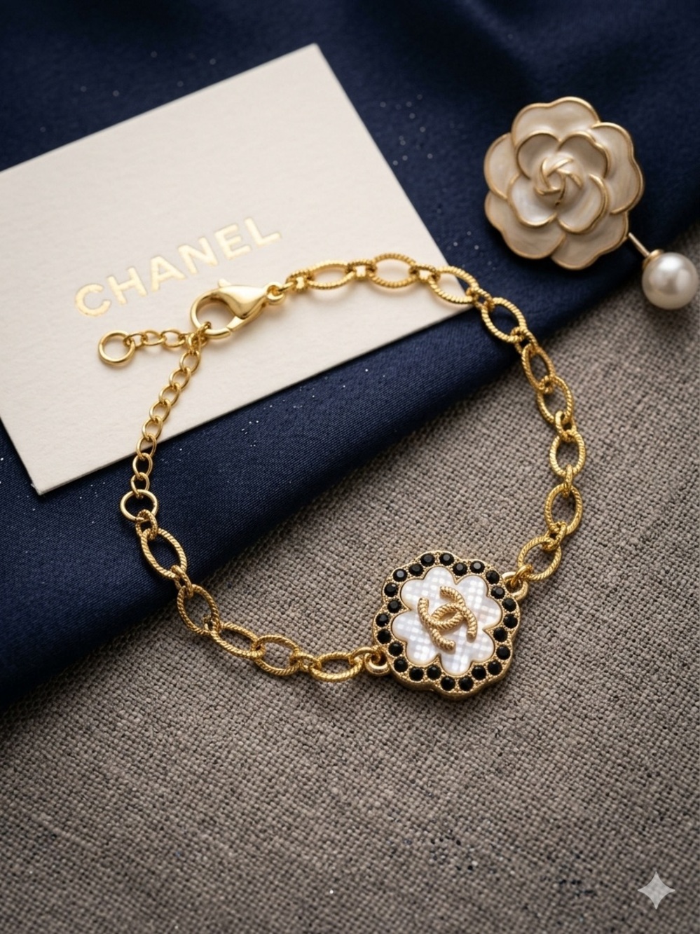 Gold Charm Bracelet with White Camellia and Black Accents